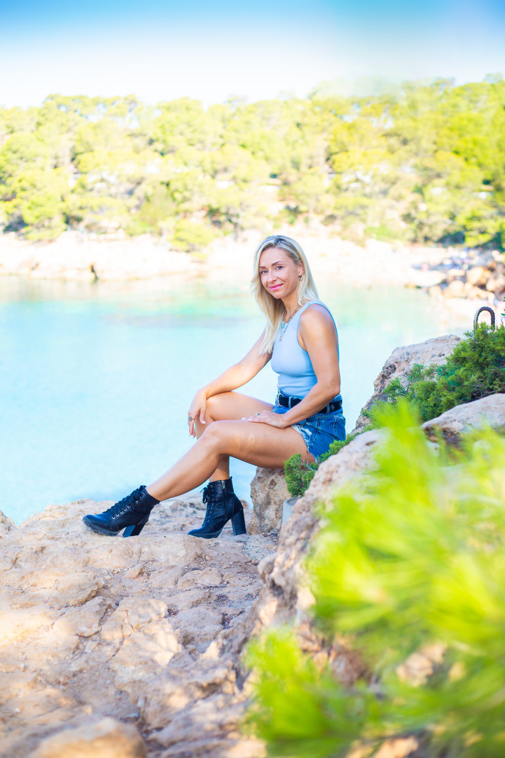 Lydia sitting by the sea in Ibiza