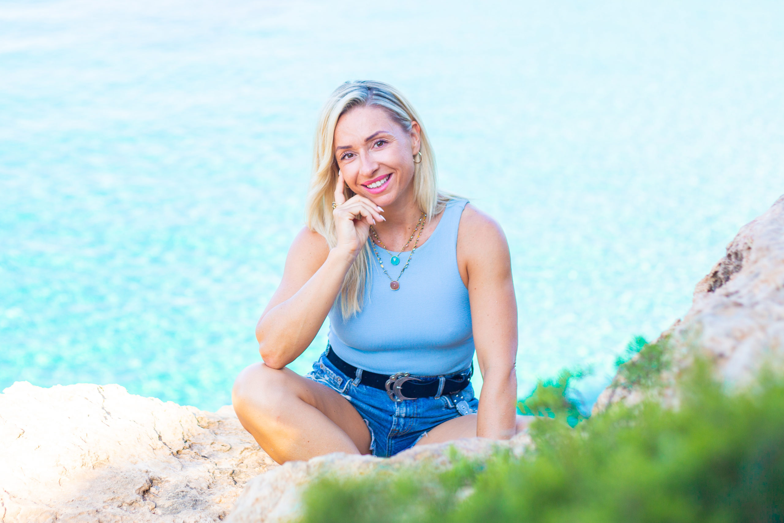 Lydia sitting by the sea in Ibiza