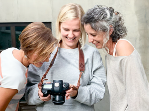 three ladies looking at a camera