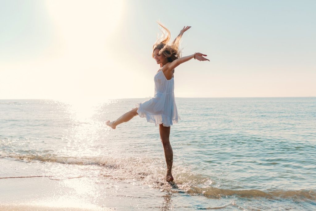 young-attractive-happy-woman-dancing-turning-around-by-sea-beach-sunny-summer-fashion-style_285396-7650 ecstasy