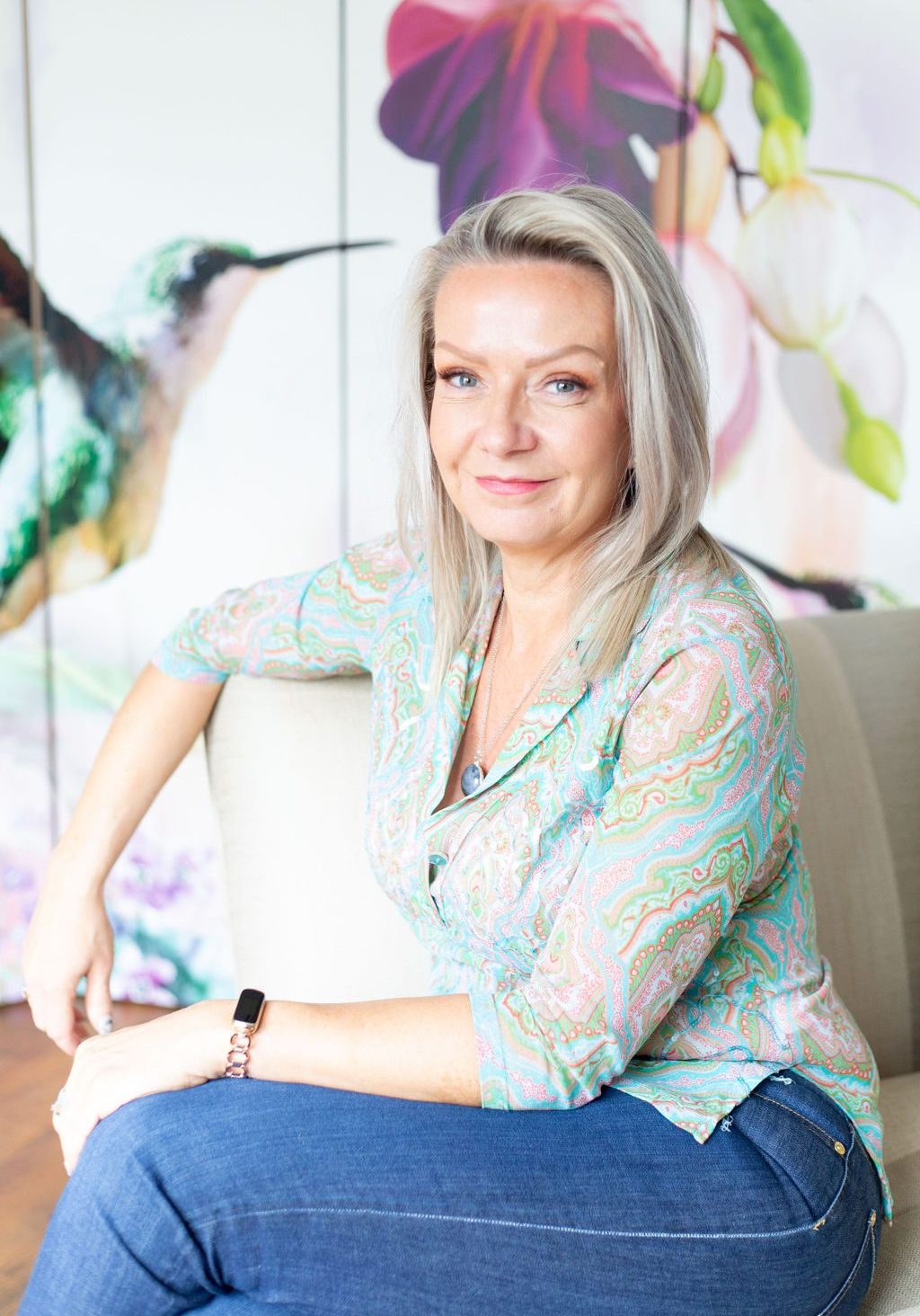 Woman sat on chair smiling